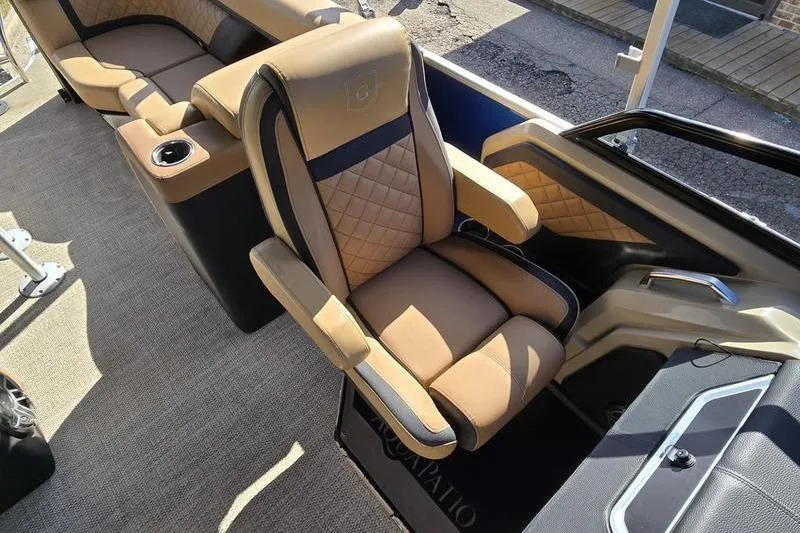 Slide: The Image of Luxurious seating on 2023 Godfrey AquaPatio 255 SBW iMPACT pontoon boat, featuring tan upholstery. - 4