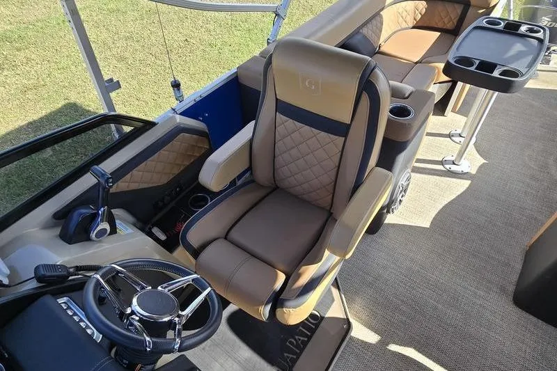 Slide: The Image of Luxurious interior of 2023 Godfrey AquaPatio 255 SBW pontoon boat with plush seating and steering. - 8
