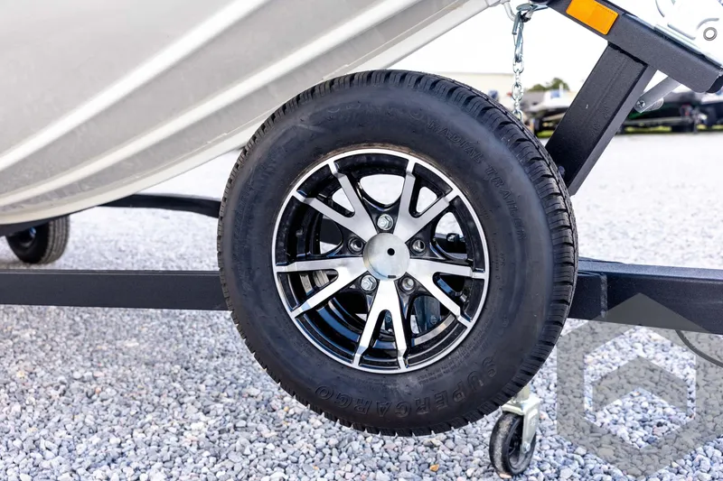 Slide: The Image of 2026 G3 Sportsman 1710 SE trailer wheel on gravel surface. - 10