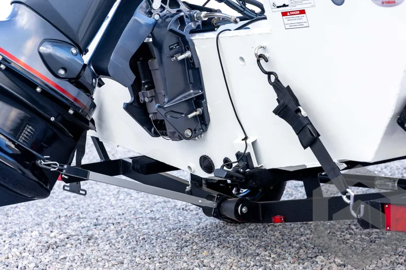 Slide: The Image of 2026 G3 Sportsman 1710 SE boat engine and trailer detail on gravel. - 18