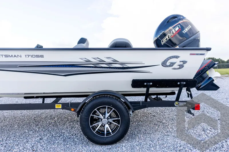 Slide: The Image of 2026 G3 Sportsman 1710 SE boat on trailer with Yamaha engine, parked on gravel. - 28