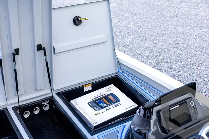 Slide: The Image of 2026 G3 Sportsman 1710 SE boat storage compartment with electronics and accessories. - 46