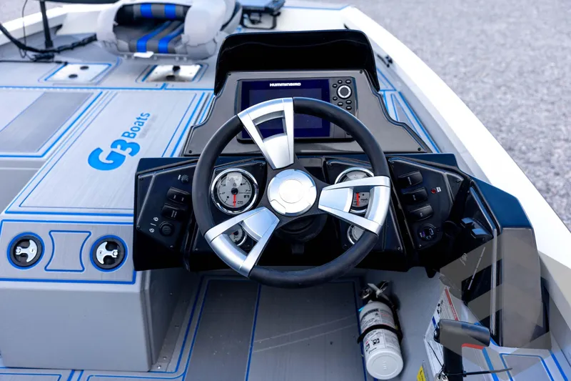 Slide: The Image of 2026 G3 Sportsman 1710 SE boat dashboard with steering wheel and control panel. - 52