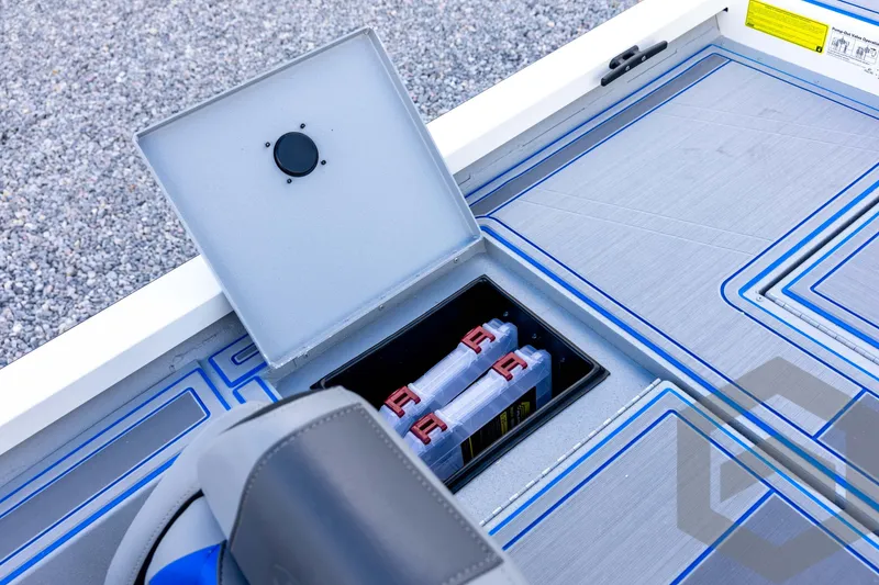 Slide: The Image of 2026 G3 Sportsman 1710 SE boat storage compartment with organized tackle boxes. - 65