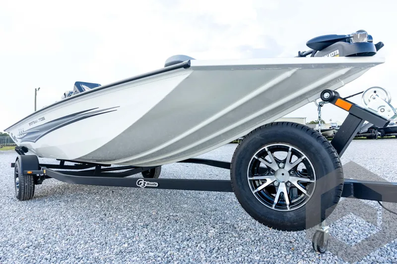 Slide: The Image of 2026 G3 Sportsman 1710 SE boat on trailer, side view, parked on gravel. - 9