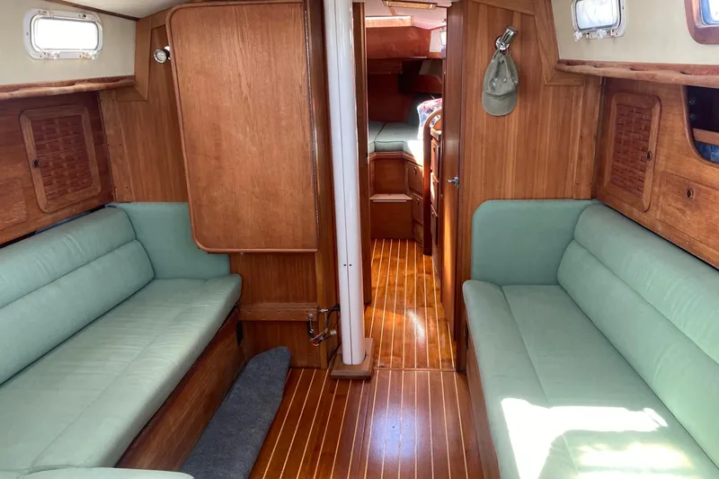Slide: The Image of 1984 Sabre MK 1 yacht interior with wooden finish and green seating. - 10