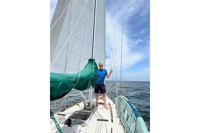 Slide: The Image of Sailboat on calm sea, Sabre MK 1, 1984, with green sail cover under clear blue sky. - 2