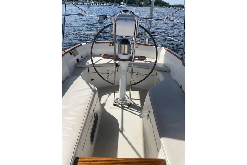 Slide: The Image of Cockpit of 1984 Sabre MK 1 sailboat with steering wheel, on calm water. - 6