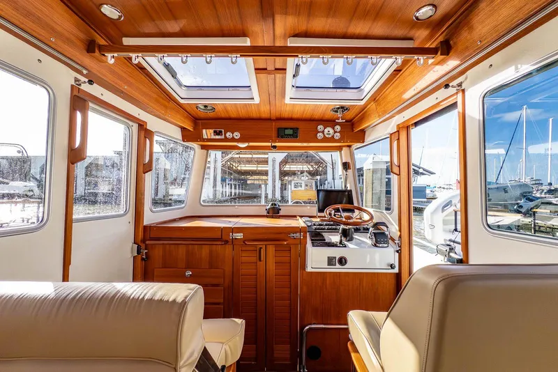 Slide: The Image of Interior of 2019 Targa 27.2 boat with wooden finish and modern controls. - 17