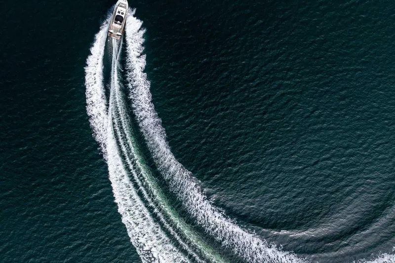 Slide: The Image of Aerial view of 2019 Targa 27.2 boat creating a curved wake on the water. - 2