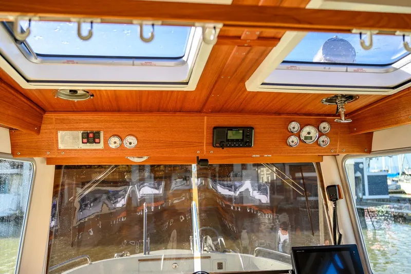 Slide: The Image of Interior view of 2019 Targa 27.2 boat cockpit with wooden paneling and navigation instruments. - 20