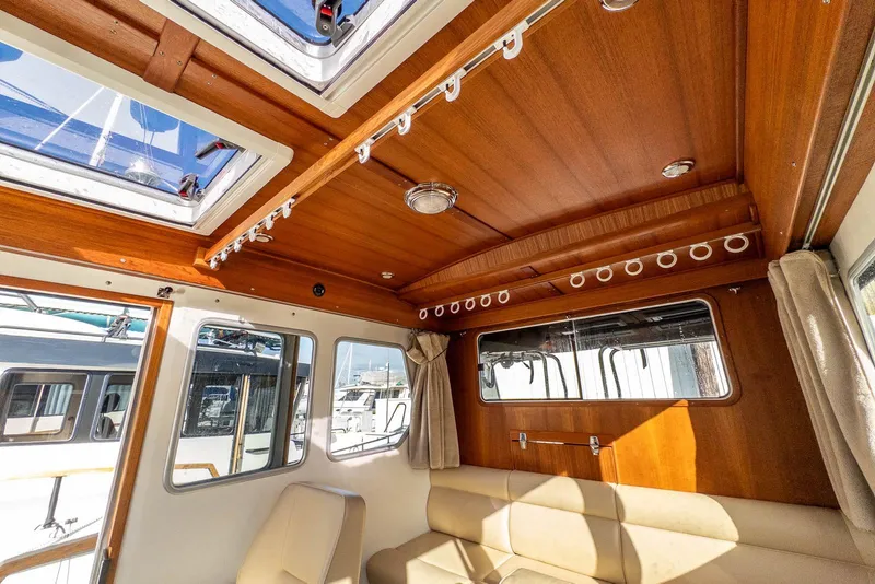Slide: The Image of Interior of 2019 Targa 27.2 boat with wooden ceiling and beige seating. - 21