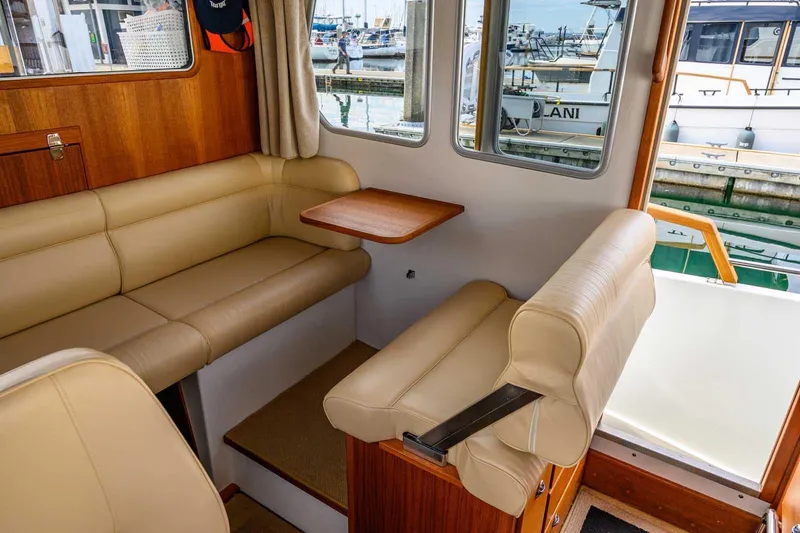 Slide: The Image of Interior of 2019 Targa 27.2 boat with beige seating and wooden accents. - 22