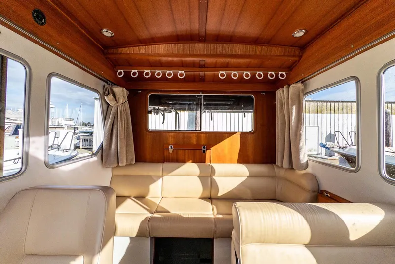 Slide: The Image of Interior of 2019 Targa 27.2 boat with beige seating and wooden accents. - 23