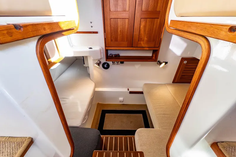 Slide: The Image of Cozy interior of 2019 Targa 27.2 boat with wooden accents and seating area. - 24