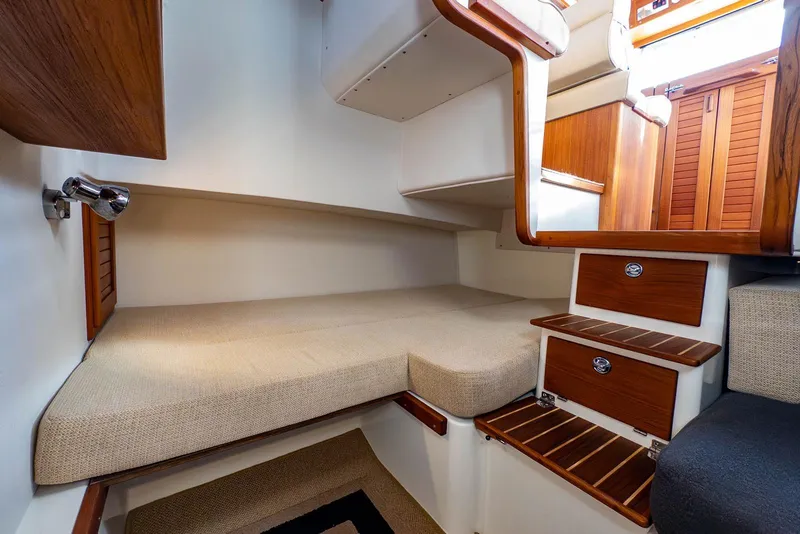 Slide: The Image of 2019 Targa 27.2 boat interior with wooden steps and cozy sleeping area. - 25