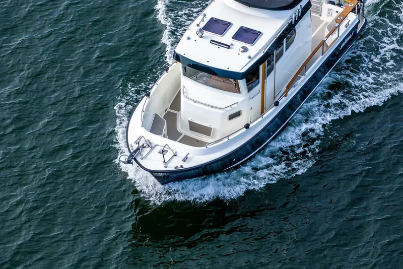 Slide: The Image of 2019 Targa 27.2 boat cruising on open water, aerial view. - 6