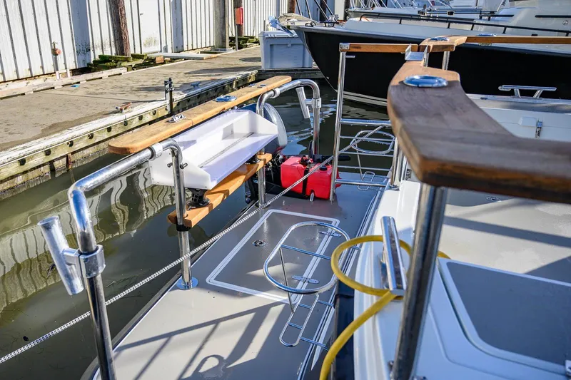 Slide: The Image of 2019 Targa 27.2 boat docked, featuring stainless steel railings and wooden accents. - 8