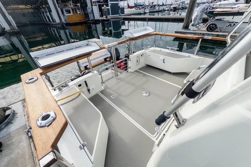 Slide: The Image of 2019 Targa 27.2 boat deck with wooden railings in a marina setting. - 9