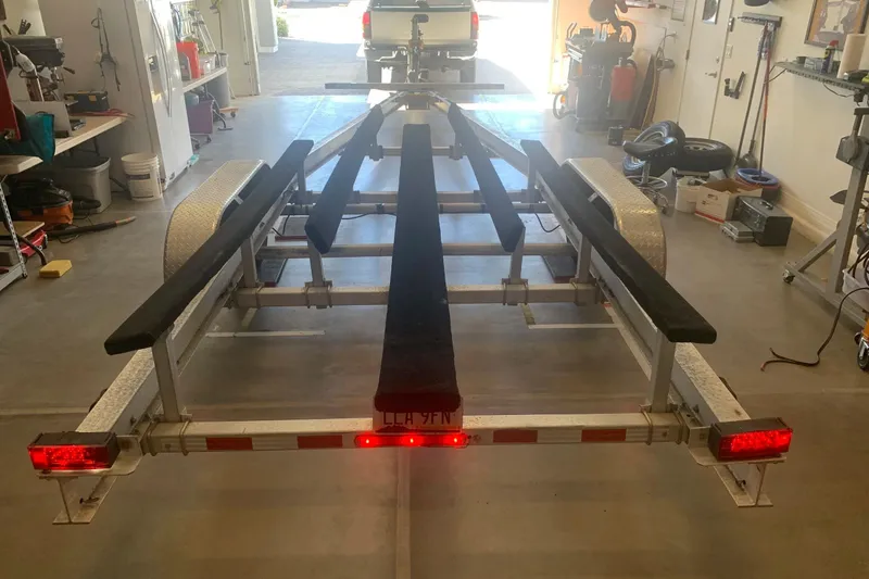 Slide: The Image of Corsair 31 UC 2001 boat trailer in a garage, rear view with red lights. - 10