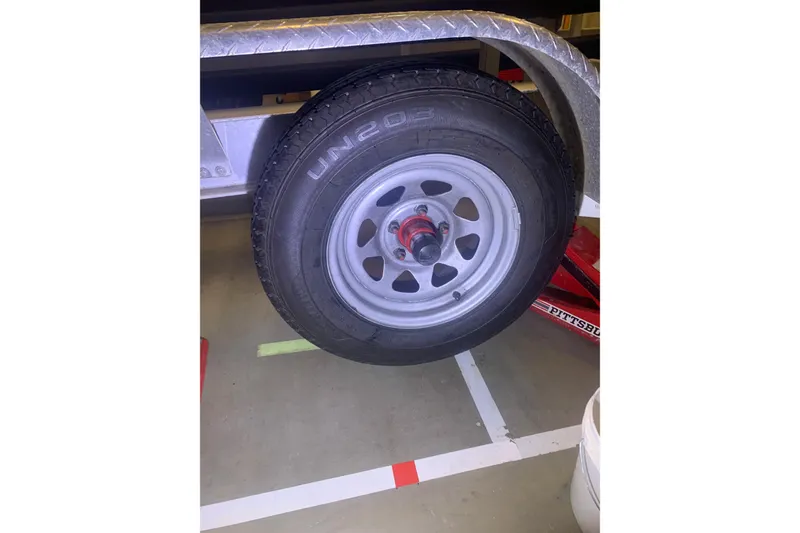Slide: The Image of Trailer wheel of a 2001 Corsair 31 UC, featuring UN203 tire on a metal rim. - 12