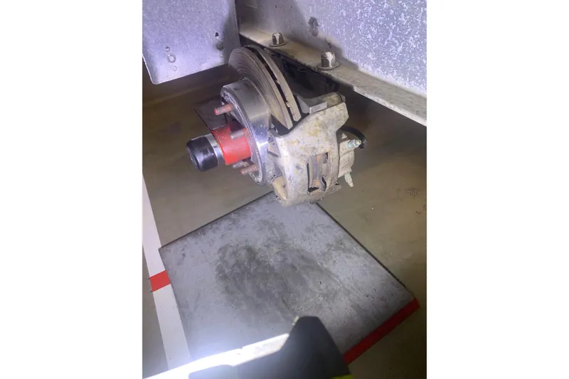 Slide: The Image of Close-up of a 2001 Corsair 31 UC brake assembly in a workshop setting. - 13