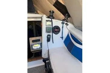 Slide: The Image of 2001 Corsair 31 UC boat interior with navigation equipment and seating area. - 7