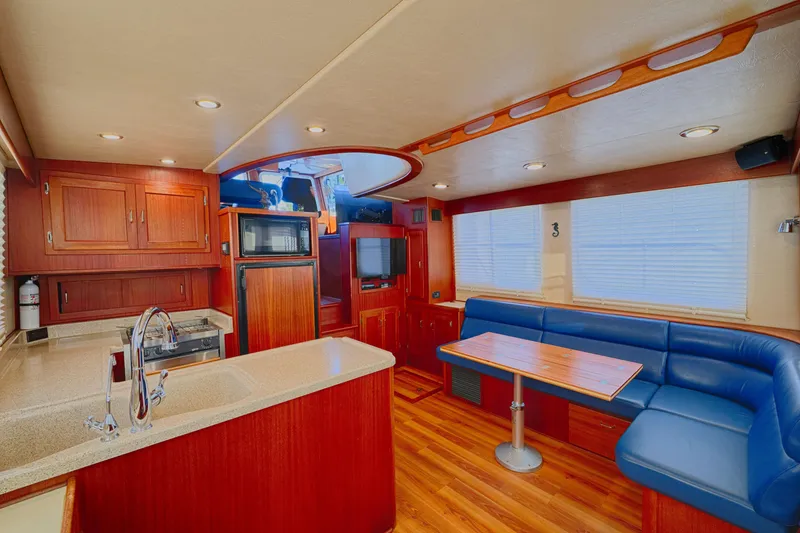 Slide: The Image of Luxurious interior of 2007 American Tug 41 with wood finishes and blue seating. - 10