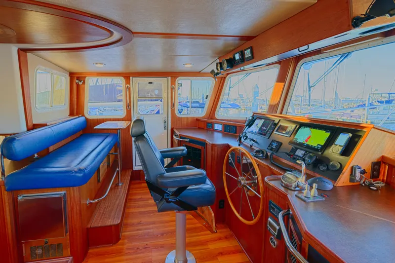 Slide: The Image of Pilothouse of 2007 American Tug 41 with navigation equipment and blue seating. - 13