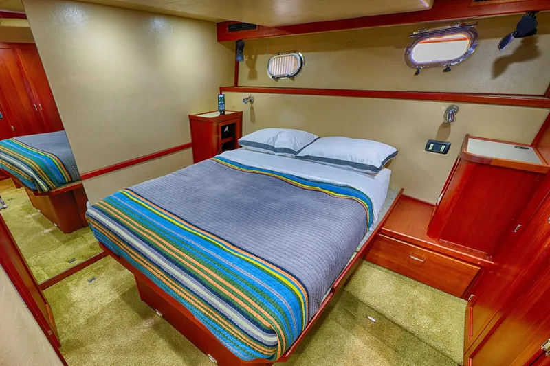 Slide: The Image of Cozy bedroom in 2007 American Tug 41 with colorful bedding and wooden cabinetry. - 18