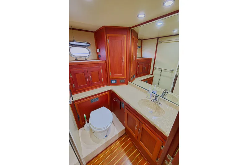 Slide: The Image of Luxurious bathroom in 2007 American Tug 41 yacht with wood cabinetry and modern fixtures. - 19