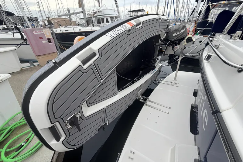 Slide: The Image of American Tug 41 (2007) docked with mounted inflatable boat and Suzuki outboard motor. - 42