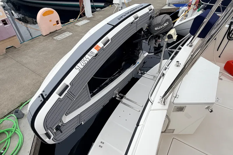 Slide: The Image of American Tug 41 (2007) with Suzuki outboard motor and docked inflatable boat. - 43