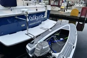 Slide: The Image of American Tug 41 (2007) docked with inflatable boat and Suzuki motor. - 44