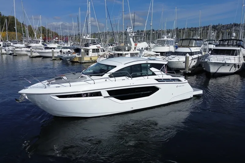 The Image of 2022 Cruisers Yachts 42 Cantius in marina, surrounded by other boats. - 0