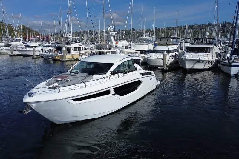 Slide: The Image of 2022 Cruisers Yachts 42 Cantius in marina, surrounded by other boats. - 24