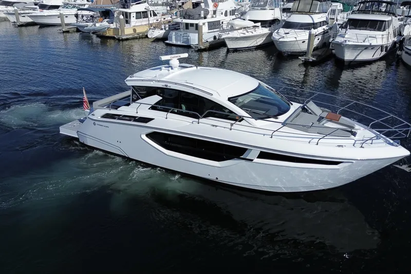 Slide: The Image of 2022 Cruisers Yachts 42 Cantius in marina, surrounded by other boats. - 26