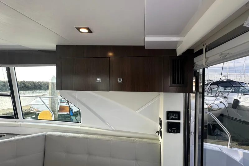Slide: The Image of Interior of 2022 Cruisers Yachts 42 Cantius with modern cabinetry and marina view. - 28