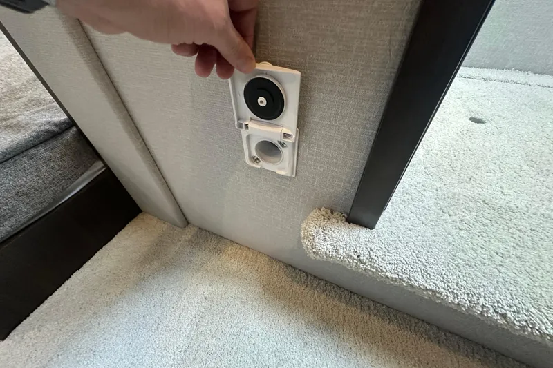 Slide: The Image of Hand adjusting outlet on 2022 Cruisers Yachts 42 Cantius interior wall. - 33