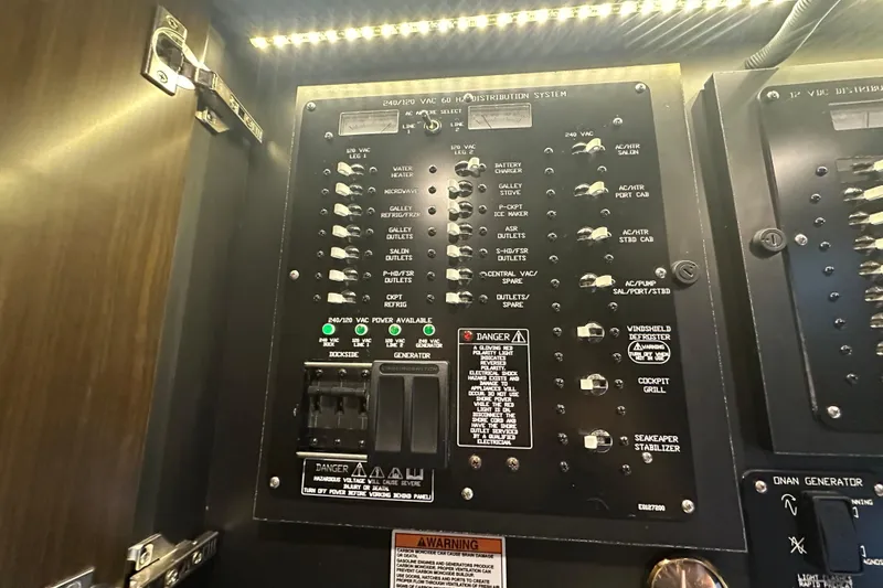 Slide: The Image of Electrical panel of 2022 Cruisers Yachts 42 Cantius with labeled switches and indicators. - 35