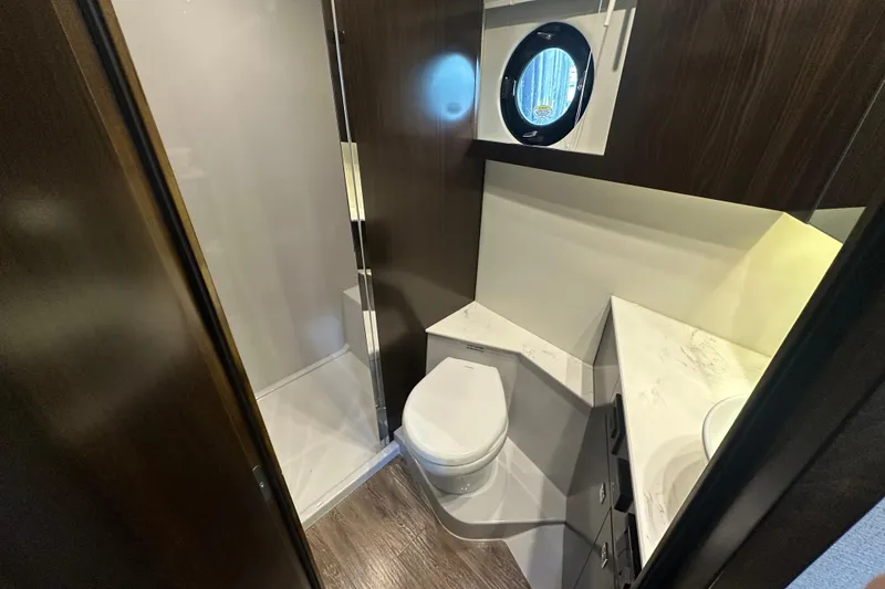 Slide: The Image of Luxurious bathroom in 2022 Cruisers Yachts 42 Cantius with modern fixtures and porthole window. - 38