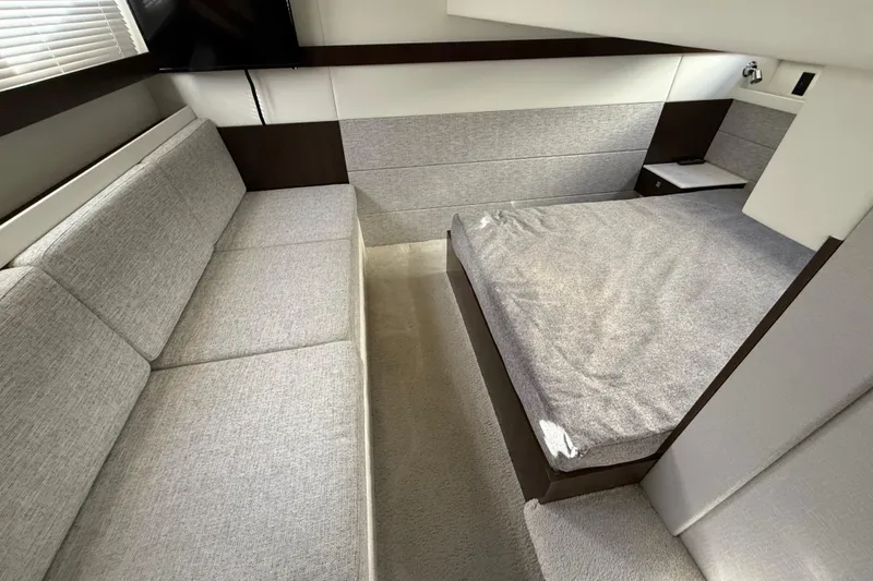 Slide: The Image of Interior of 2022 Cruisers Yachts 42 Cantius, featuring modern seating and bed. - 4