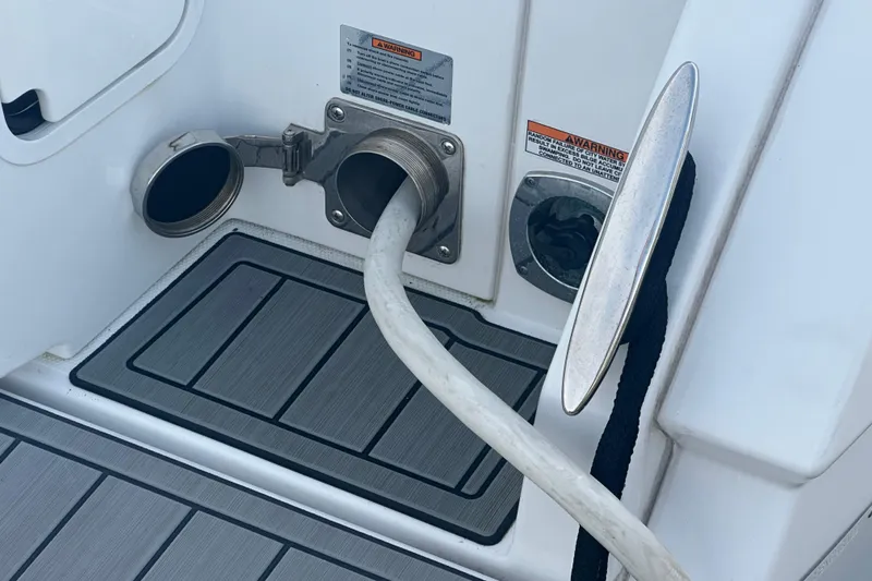 Slide: The Image of 2022 Cruisers Yachts 42 Cantius deck with hose connection and warning labels. - 46