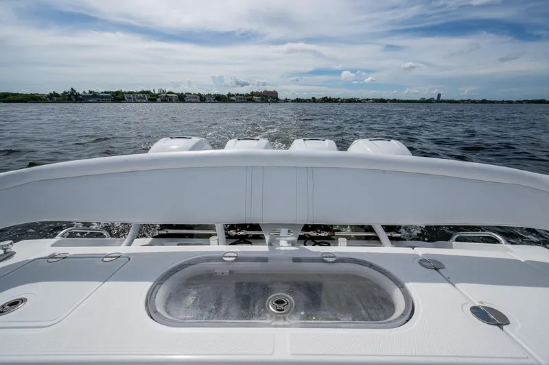 Slide: The Image of 2015 Bahama 41 boat on water, showcasing rear deck and engines. - 11