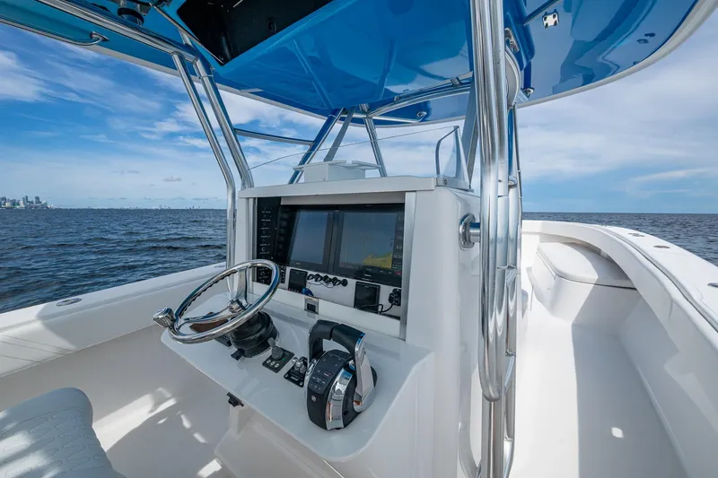 Slide: The Image of 2015 Bahama 41 boat helm with modern controls and ocean view. - 16