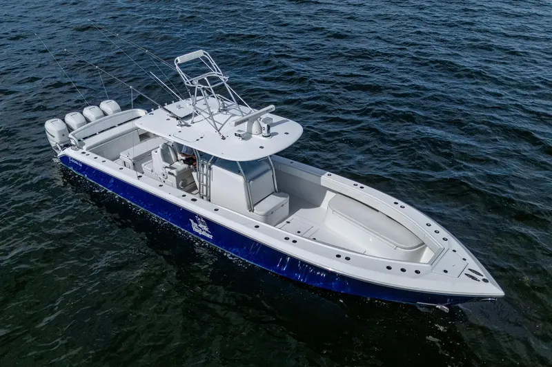 Slide: The Image of 2015 Bahama 41 boat on water, featuring sleek design and multiple outboard engines. - 21