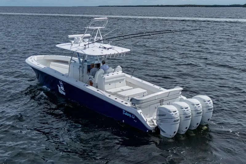 Slide: The Image of 2015 Bahama 41 boat with four 400 horsepower engines cruising on open water. - 26