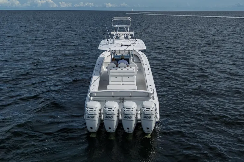 Slide: The Image of 2015 Bahama 41 boat with four Mercury engines on open water. - 27