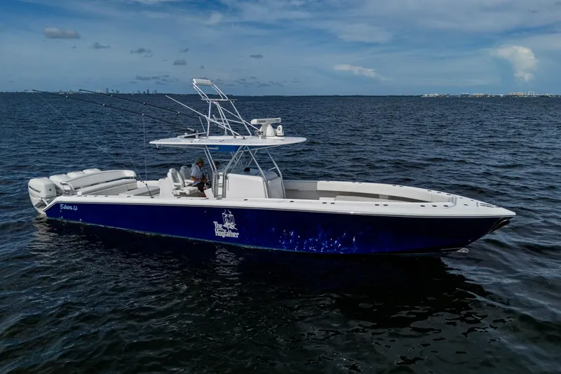 Slide: The Image of 2015 Bahama 41 boat on open water, featuring dual Mercury engines. - 30