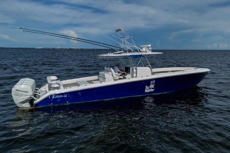 Slide: The Image of 2015 Bahama 41 boat on open water, city skyline in background. - 31